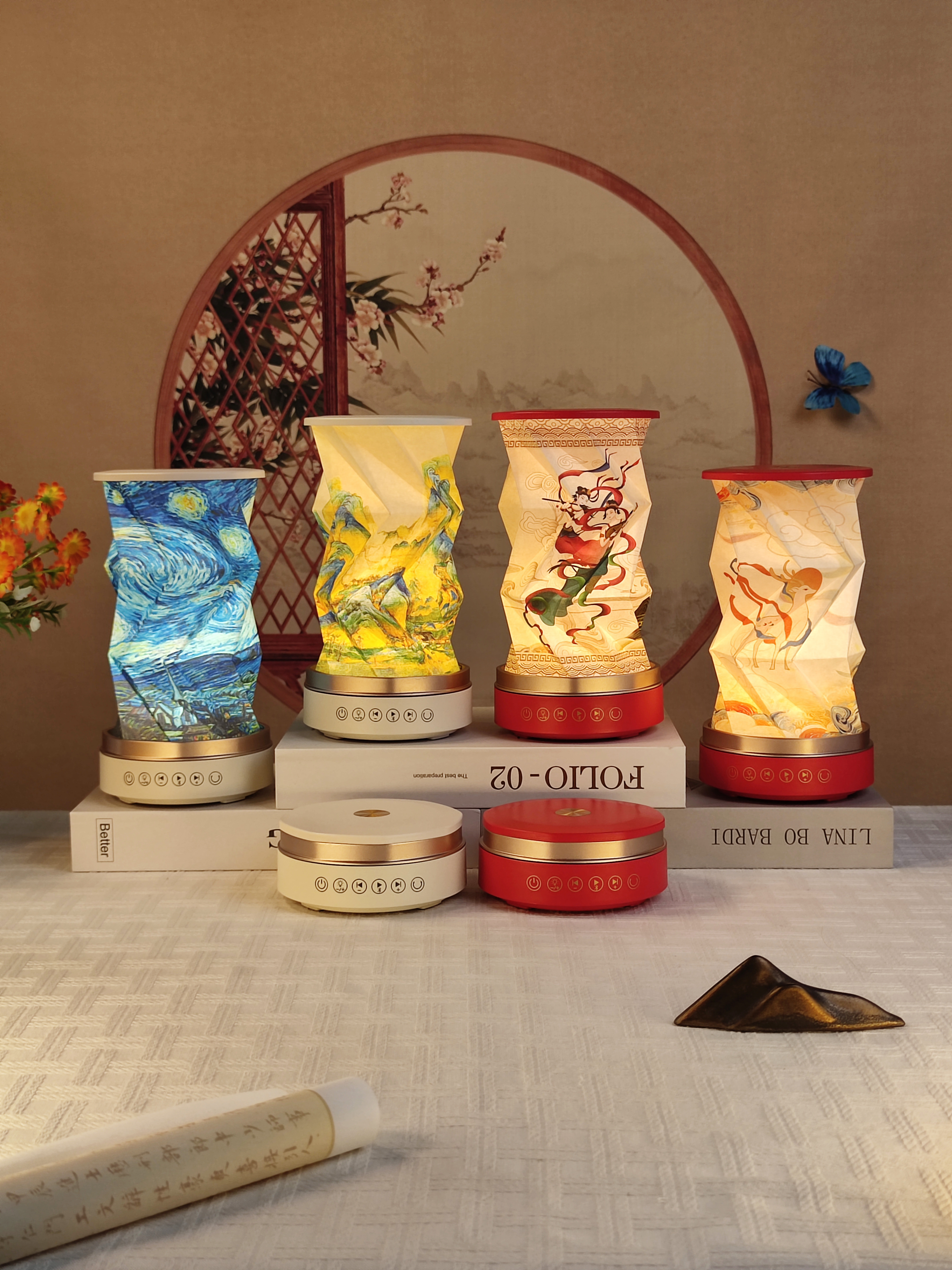 Four different art designs displayed on table